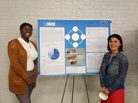 Keylaiha Brown (McNair Scholar) presenting a poster with another researcher